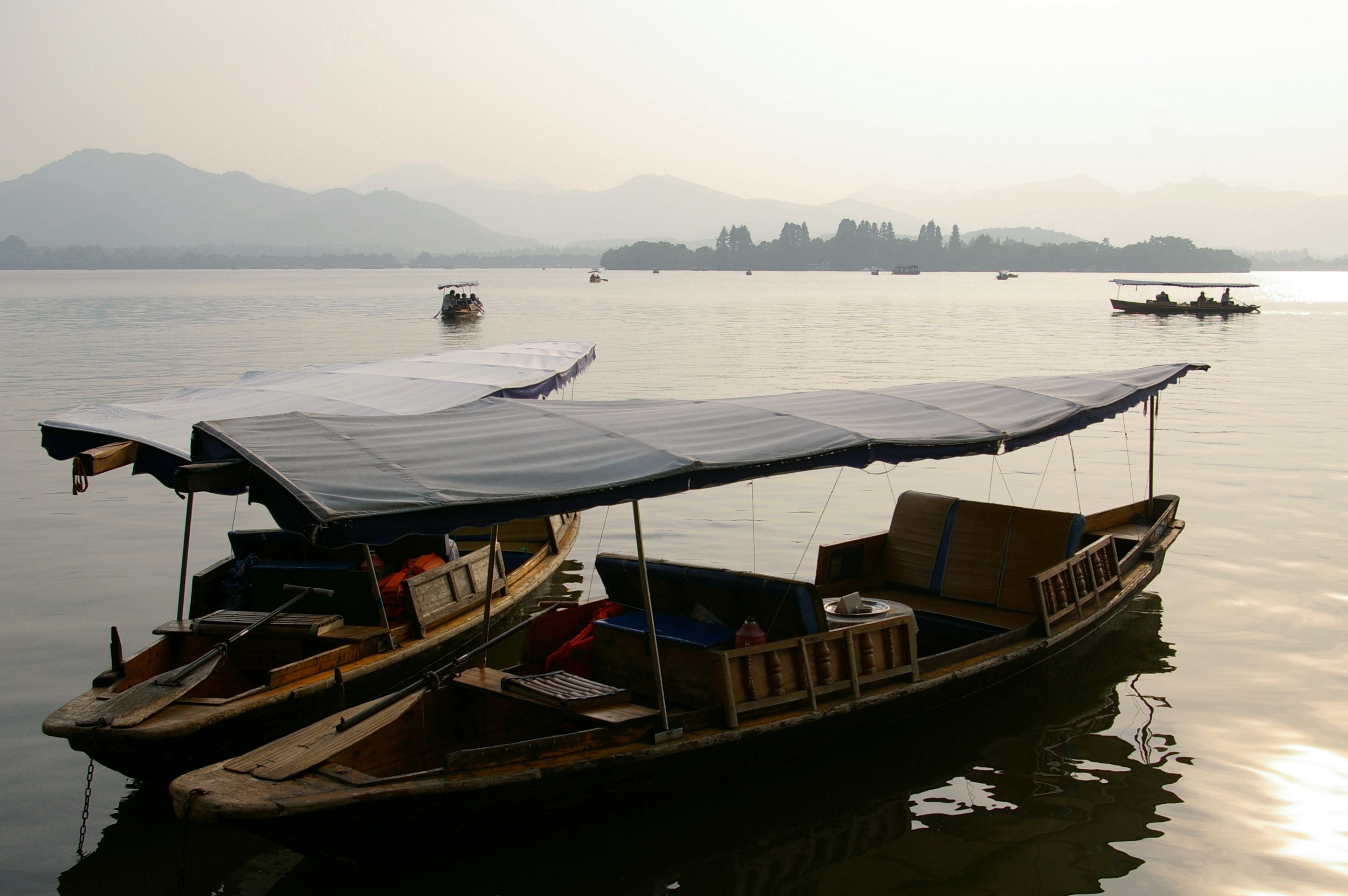 Boats on West Lake in Hangzhou under clear autumn light