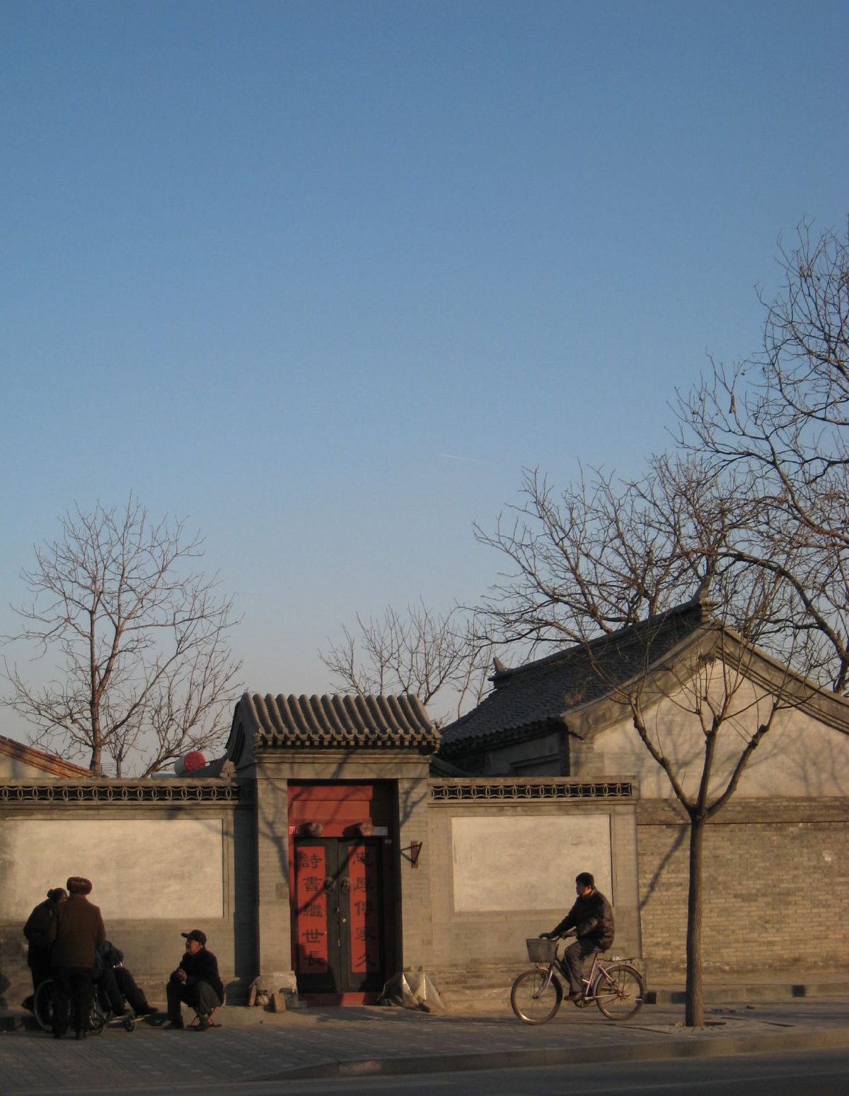 A quiet Beijing hutong alley in autumn light