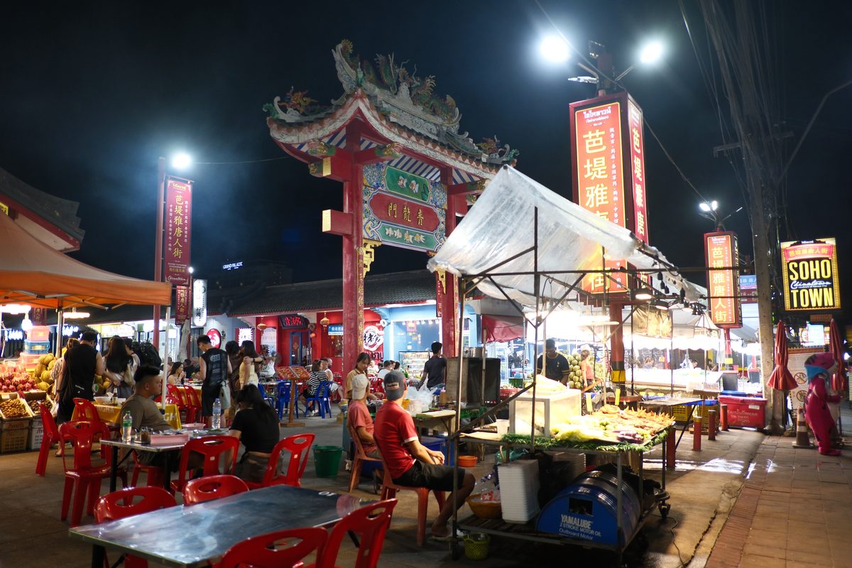 A busy tourist market street lined with stalls