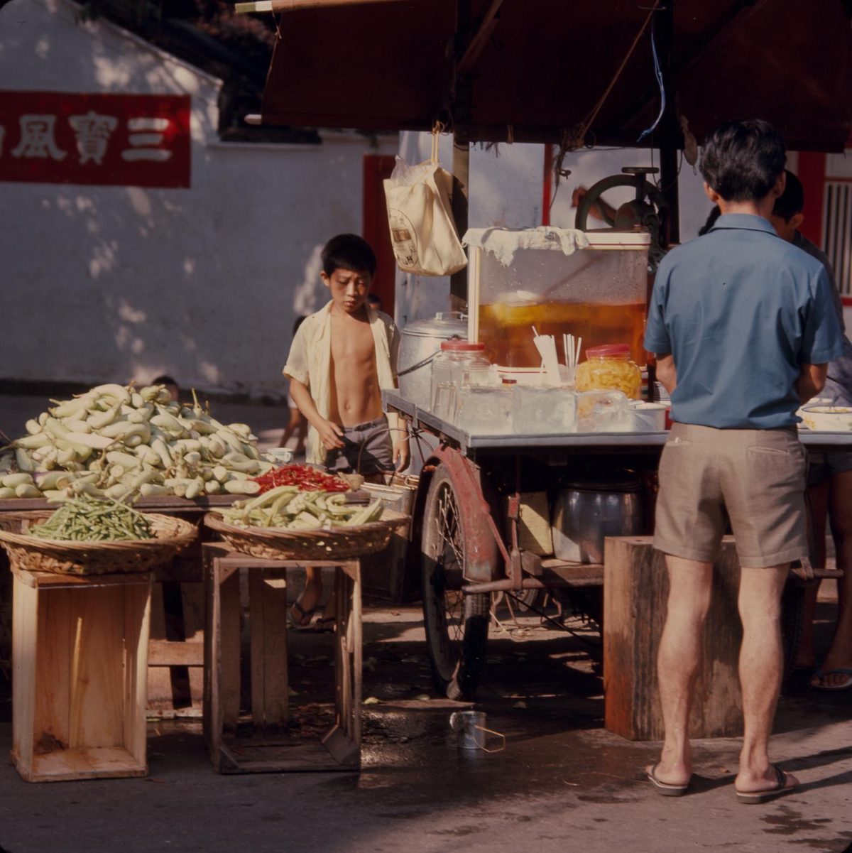 A market vendor arranging goods on a stall