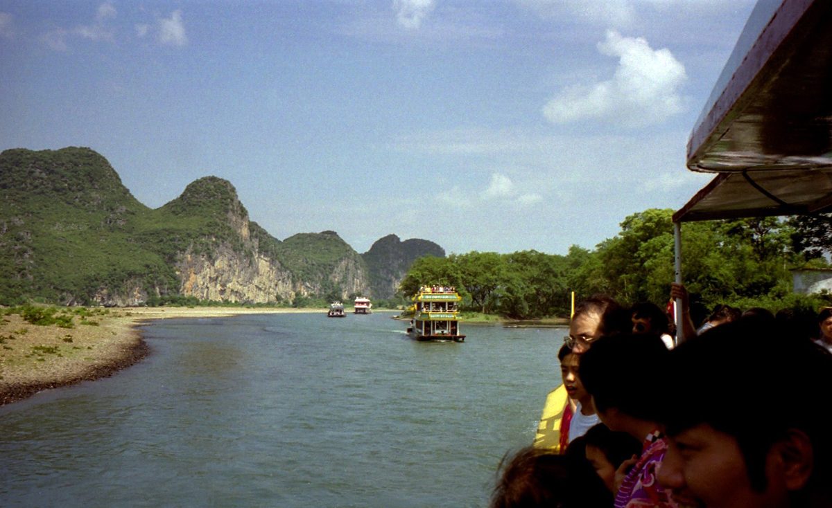 Boats on the Li River with karst peaks rising behind them near Guilin