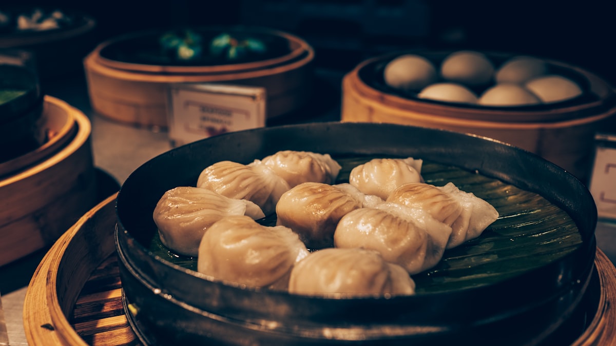 Fluffy baozi steamed buns in a bamboo basket