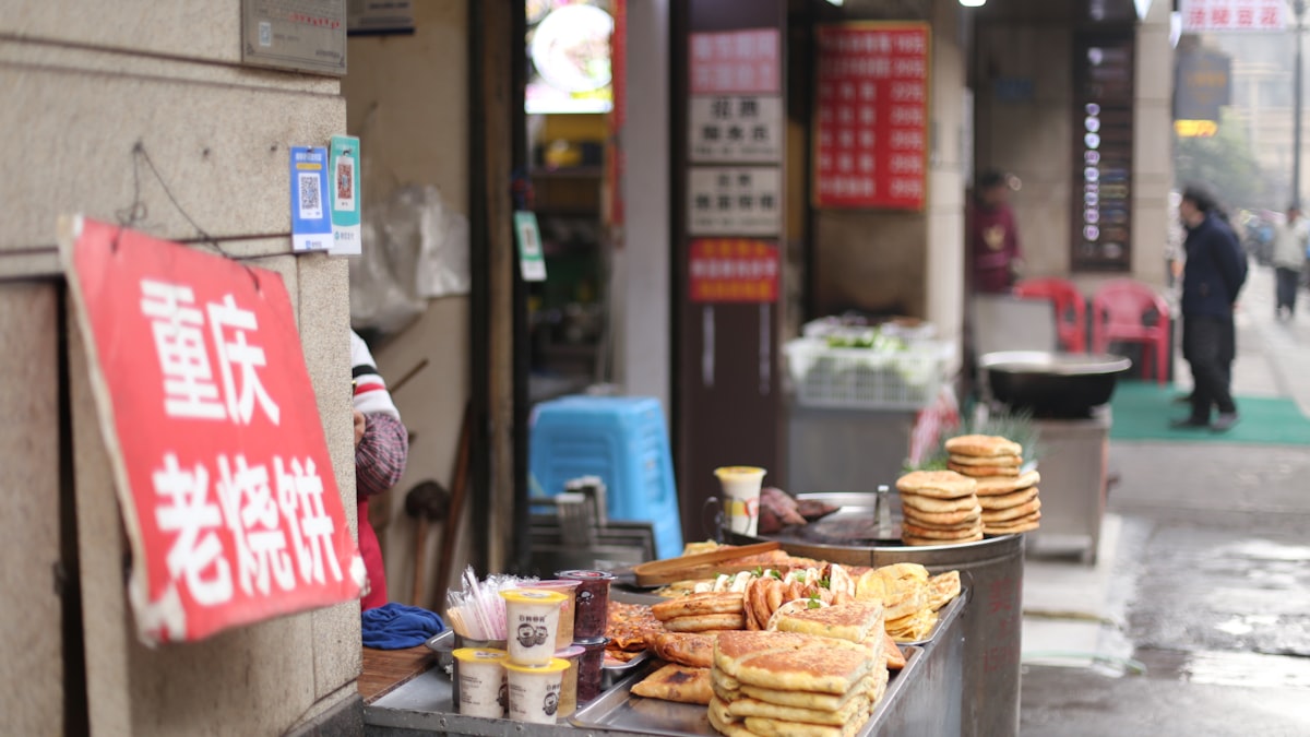 A jianbing breakfast crêpe folded on a street-cart griddle