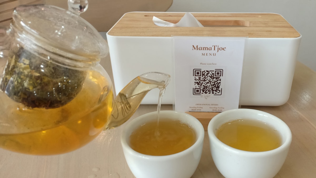A pot of Chinese tea being poured for a yum cha session