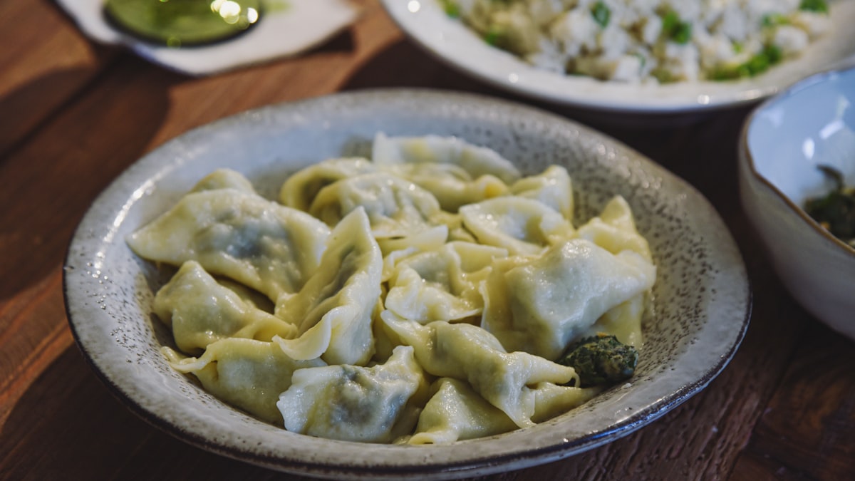Boiled jiaozi dumplings served with black vinegar