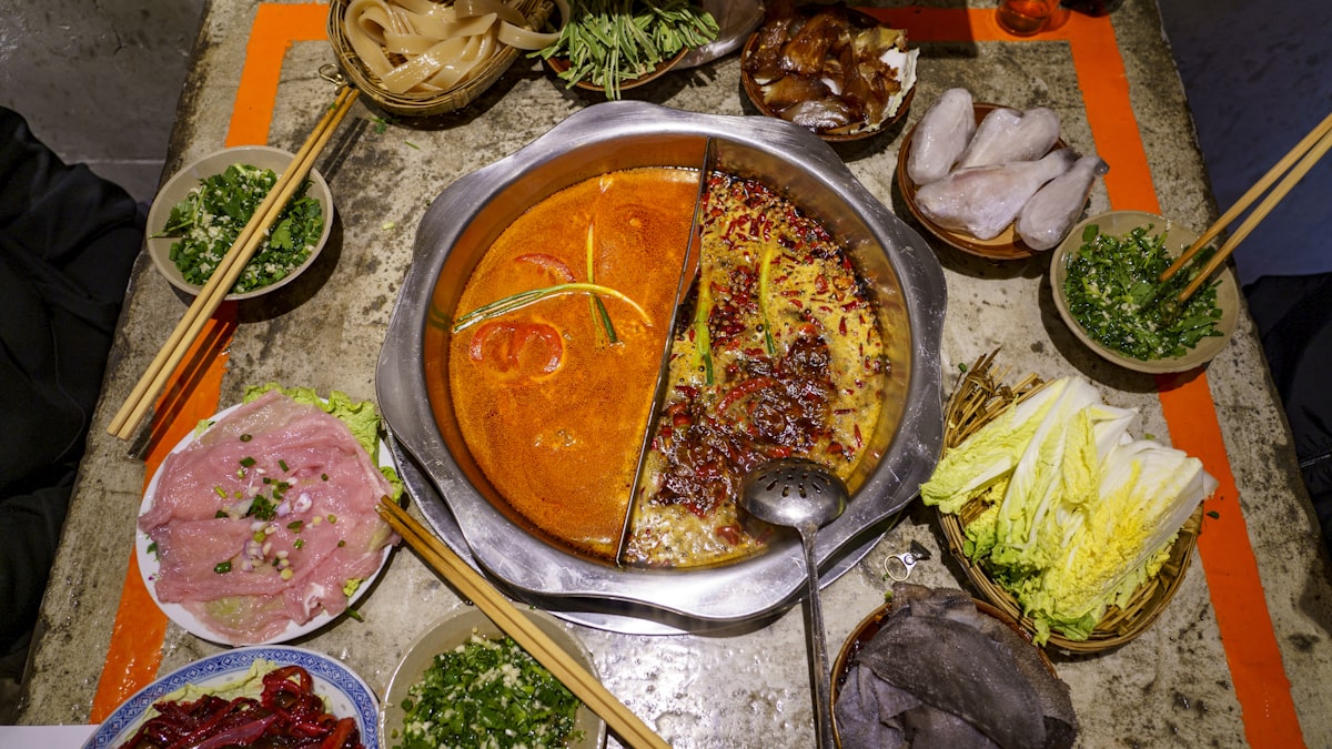 A bubbling Sichuan hotpot with a red, spicy broth