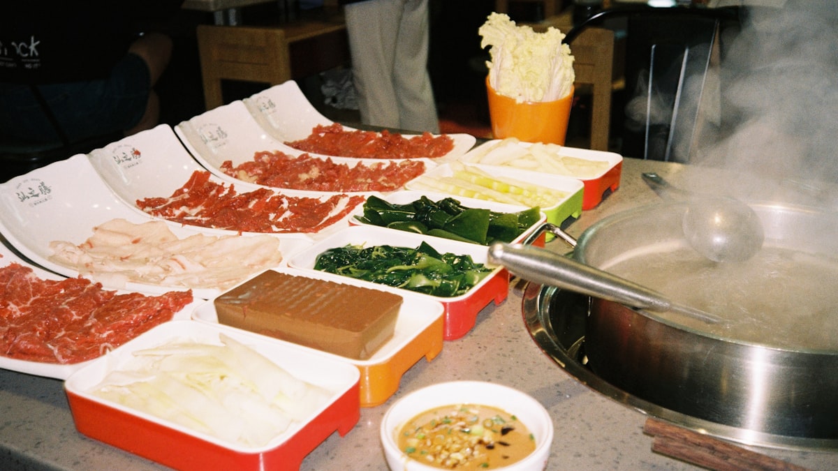 Thin-sliced meat and vegetables arranged as hotpot ingredients