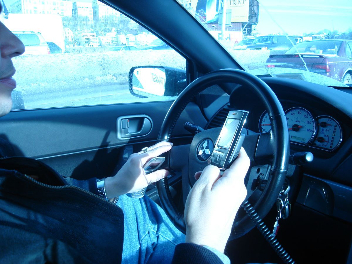 File:Hand held phone in car.JPG